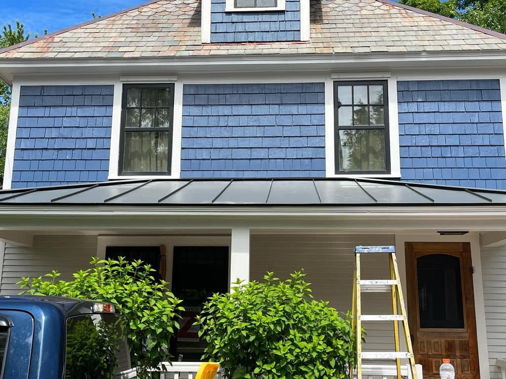 Blue shingle home with white trim